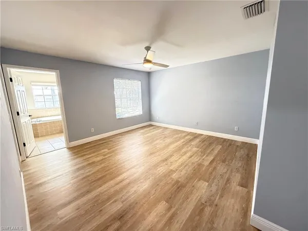 a bathroom with a granite countertop sink a toilet a mirror and shower