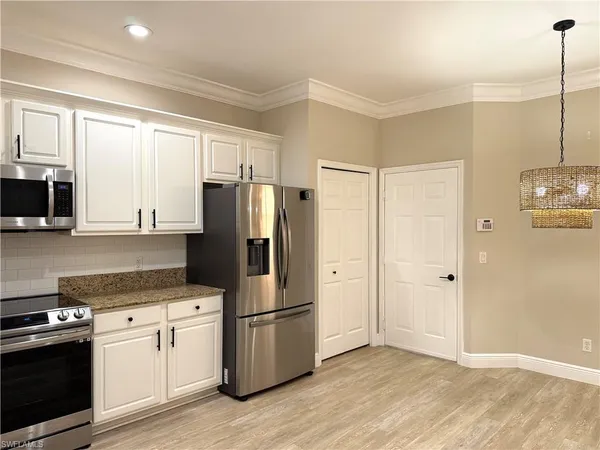 a kitchen with stainless steel appliances a refrigerator stove and microwave
