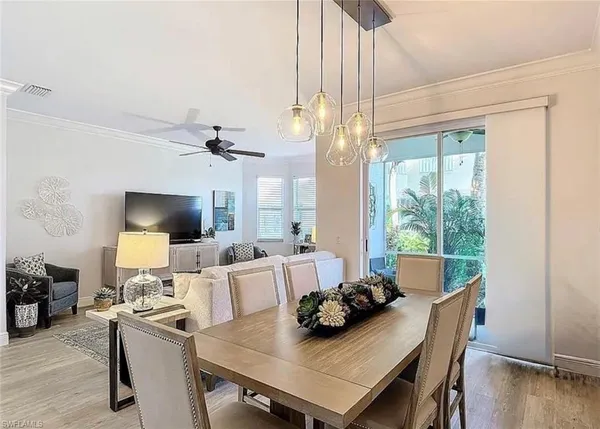 a view of a dining room with furniture window and wooden floor