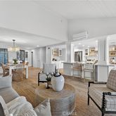 a living room with furniture and view of kitchen