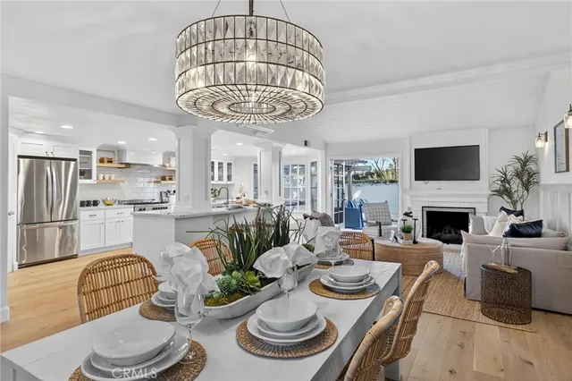 a living room with furniture a chandelier and a fireplace