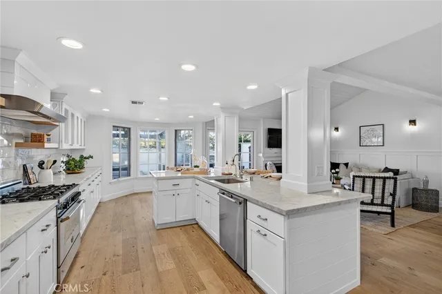 a large kitchen with stainless steel appliances lots of counter top space