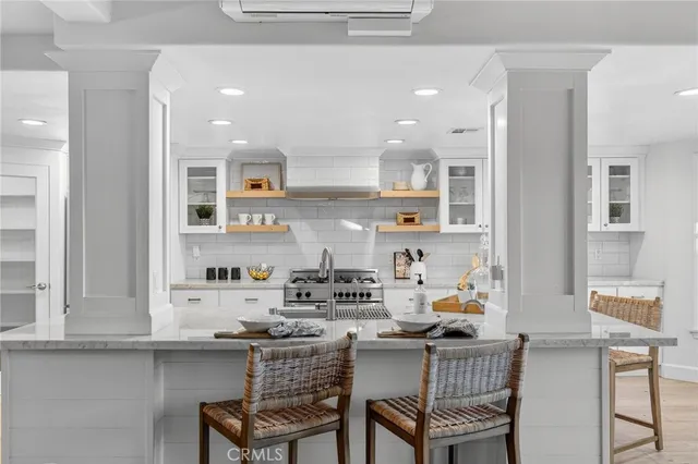 a kitchen with a dining table chairs and cabinets