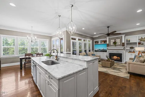 a living room with furniture large window and fireplace