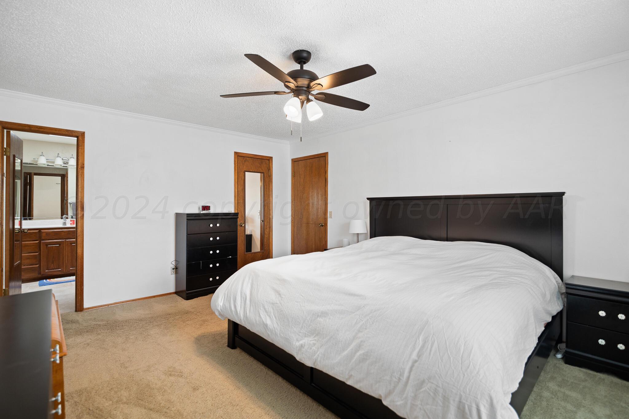 4202 Charles Street Amarillo, TX 79106 - Photo 13 of 25 a bedroom with a bed and a closet