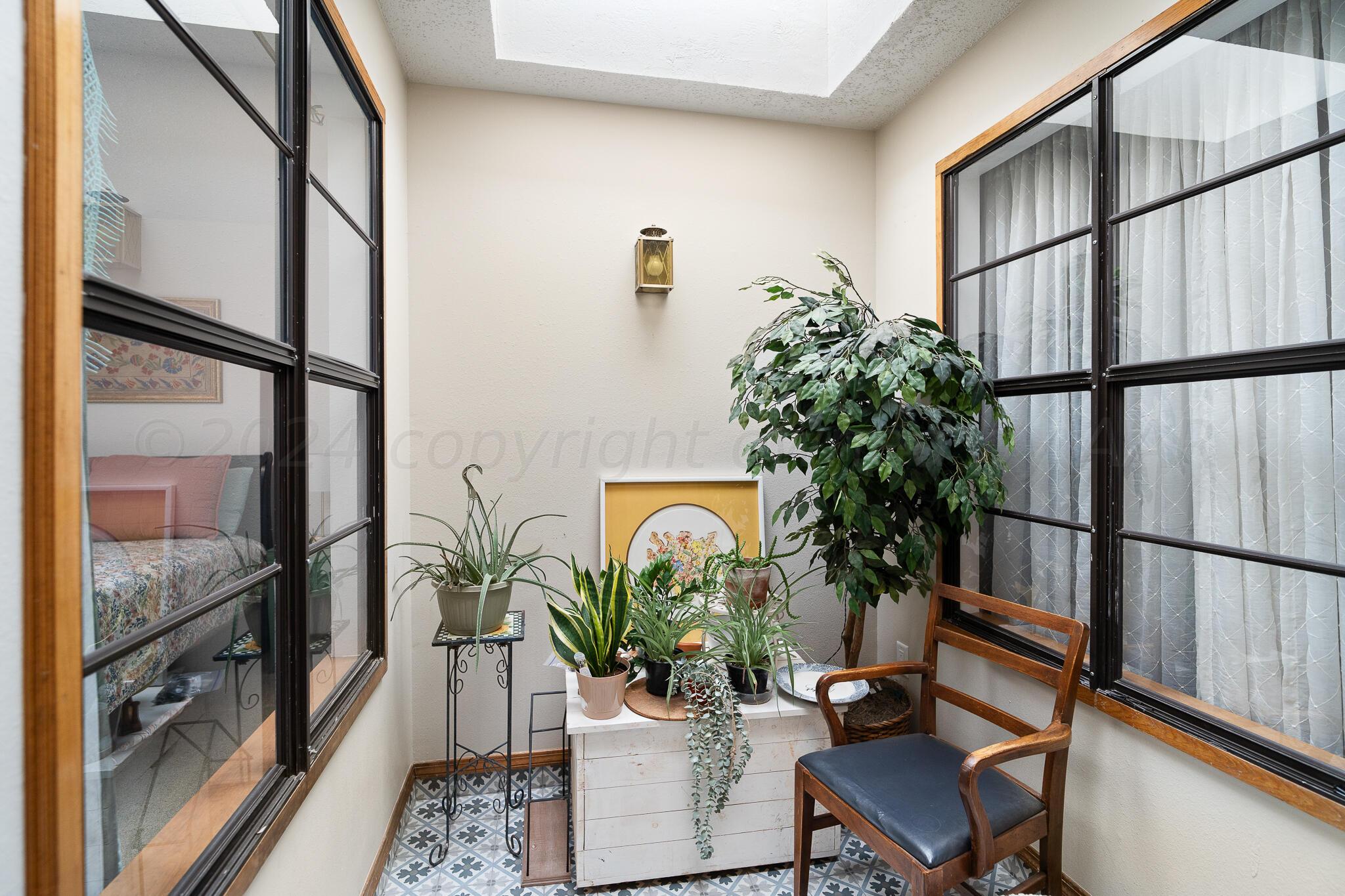 4202 Charles Street Amarillo, TX 79106 - Photo 18 of 25 a view of an entryway with wooden floor and a potted plant on a table