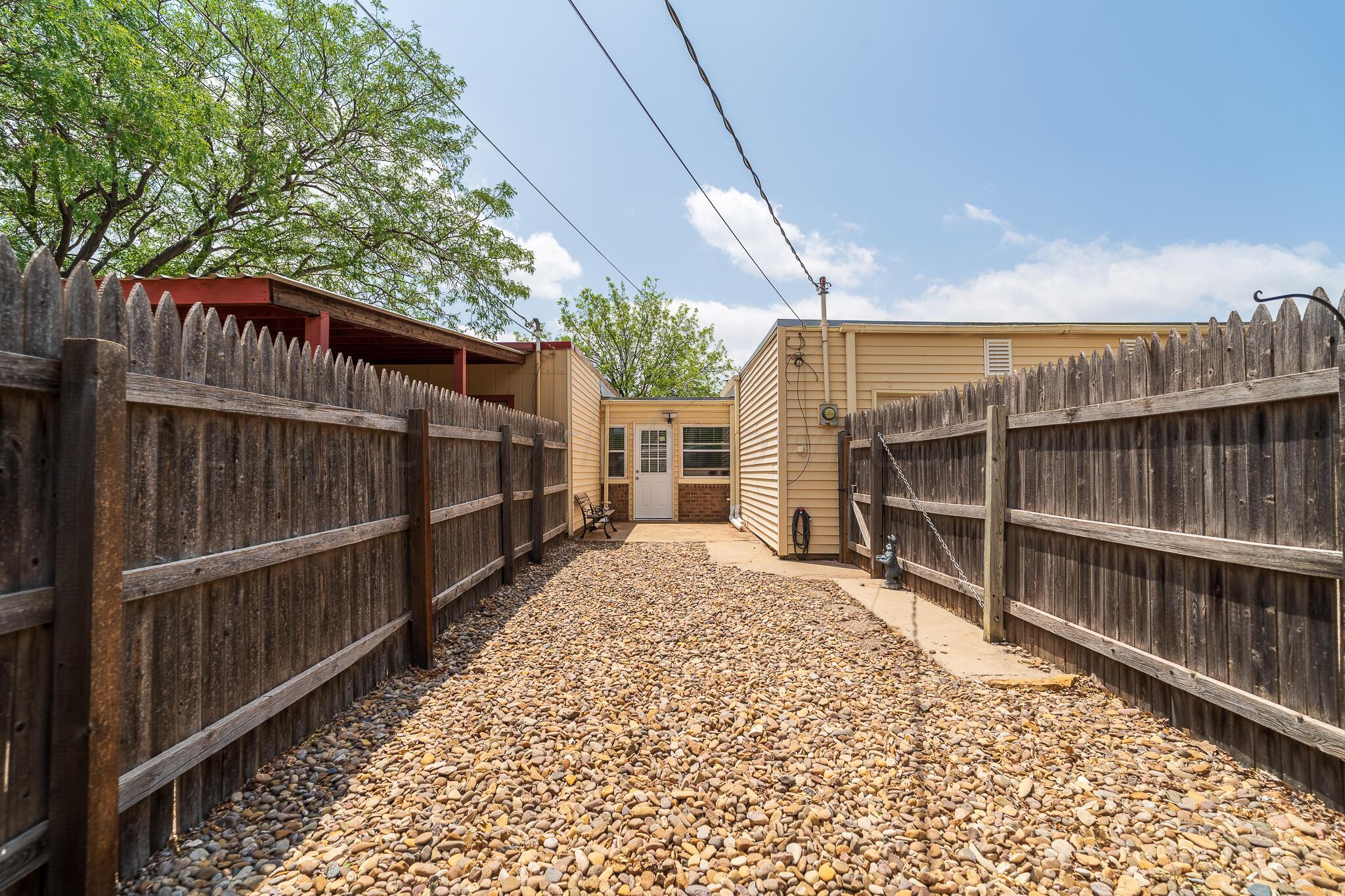 4202 Charles Street Amarillo, TX 79106 - Photo 24 of 25 a view of a pathway of a house with wooden fence