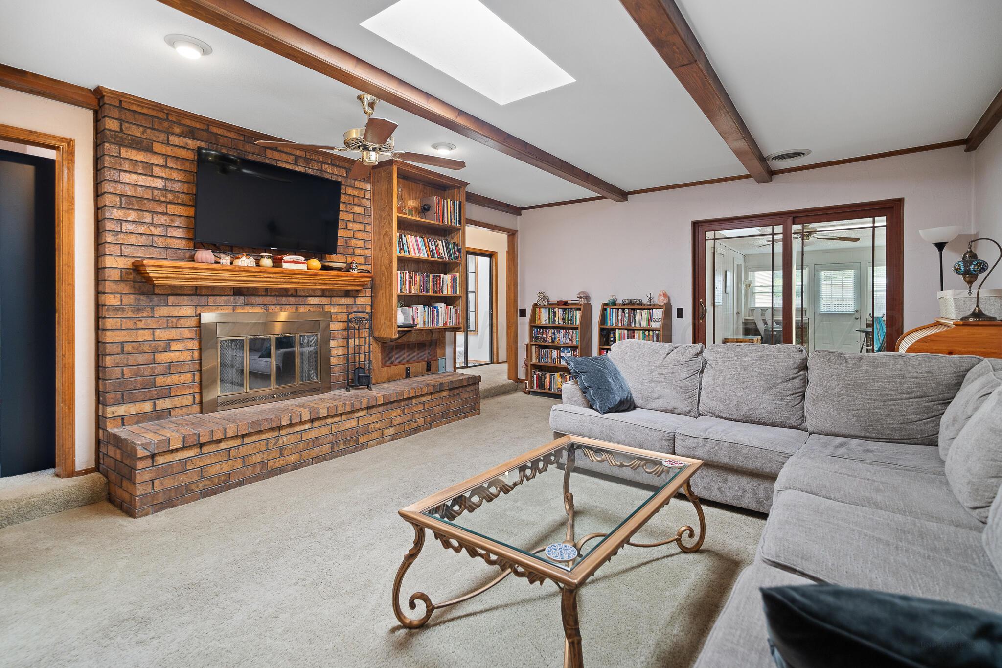 4202 Charles Street Amarillo, TX 79106 - Photo 6 of 25 a living room with furniture and a flat screen tv