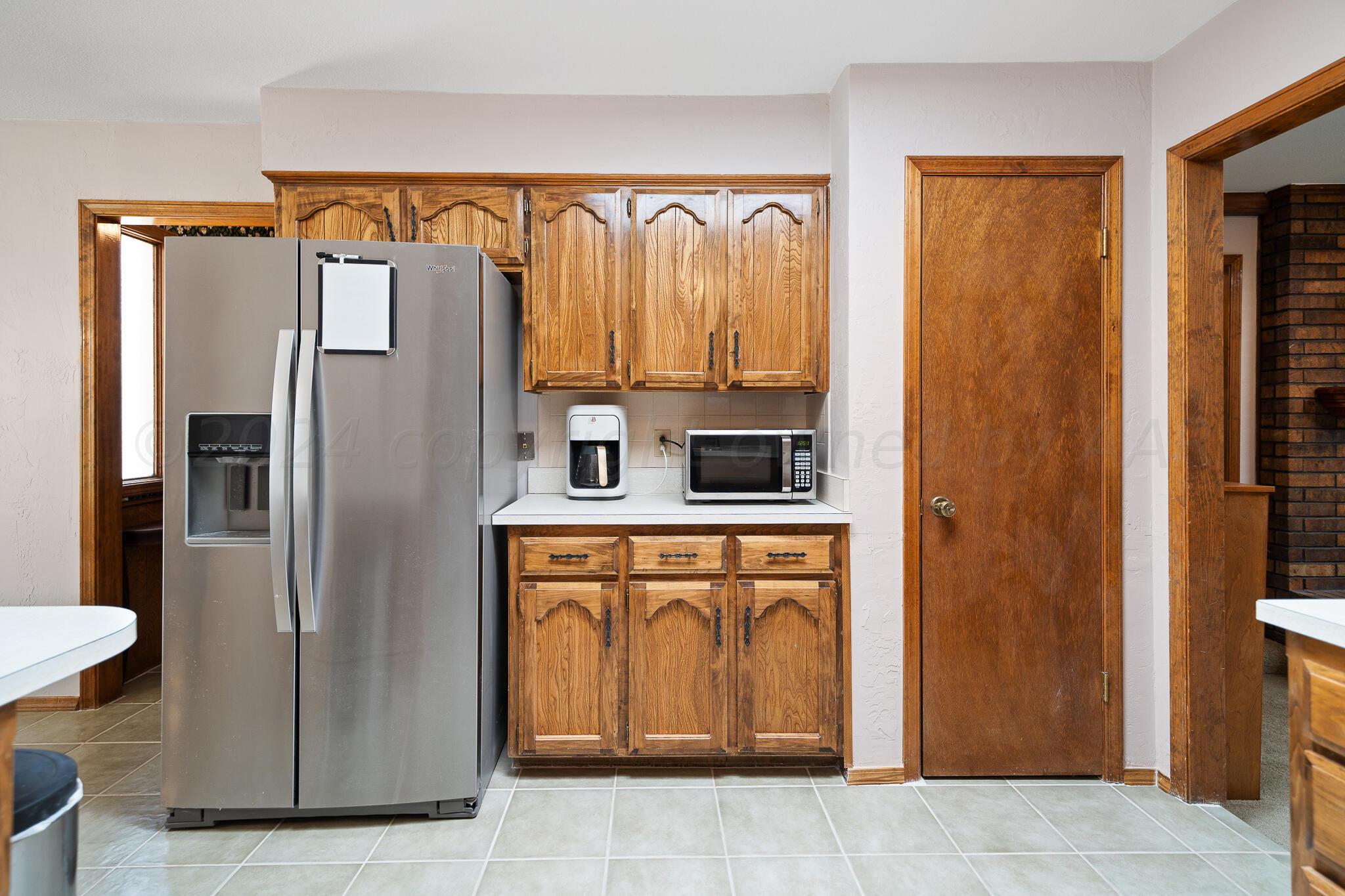 4202 Charles Street Amarillo, TX 79106 - Photo 8 of 25 a metallic refrigerator freezer sitting in a kitchen