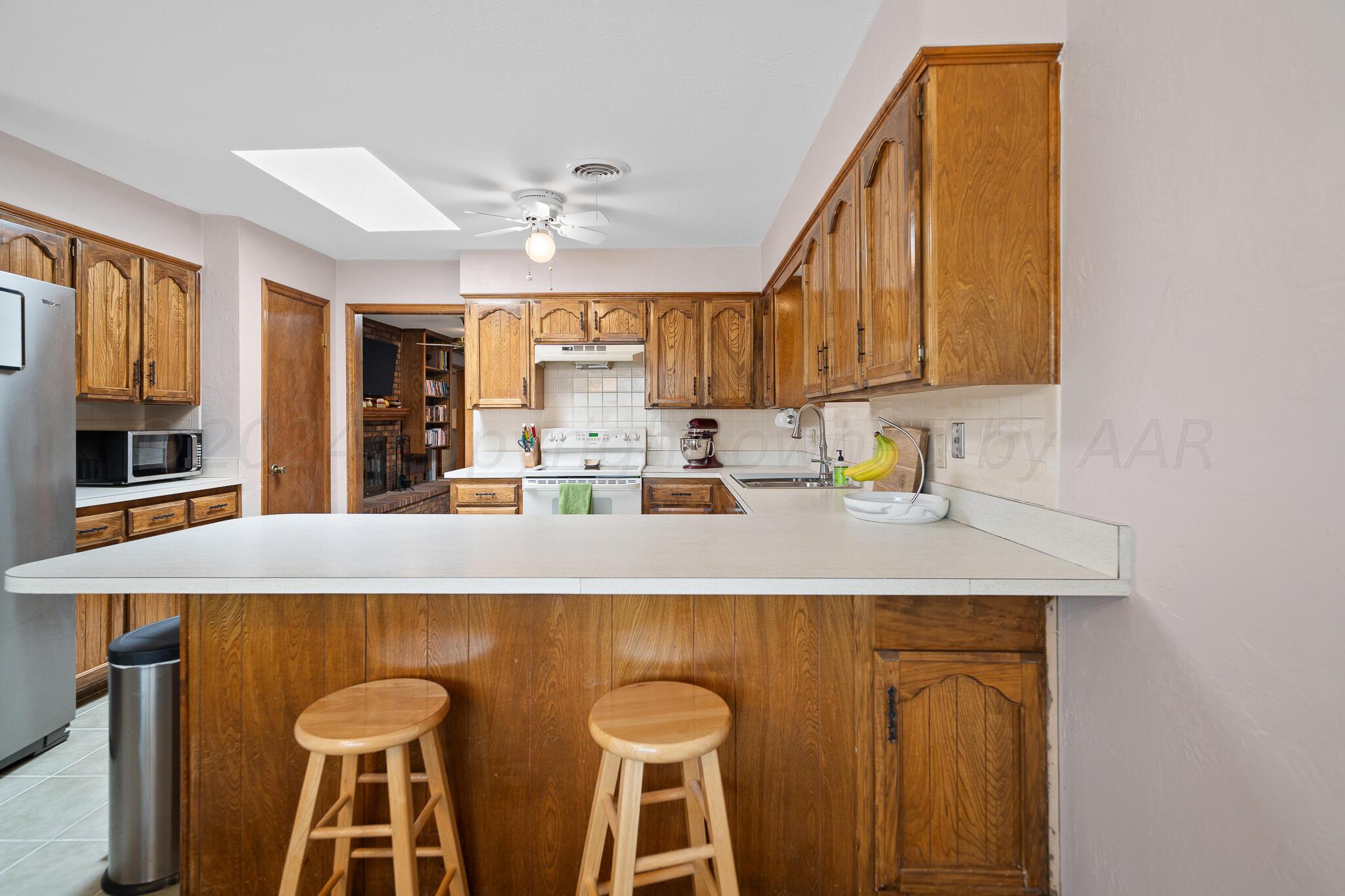 4202 Charles Street Amarillo, TX 79106 - Photo 9 of 25 a kitchen with a table chairs sink and cabinets