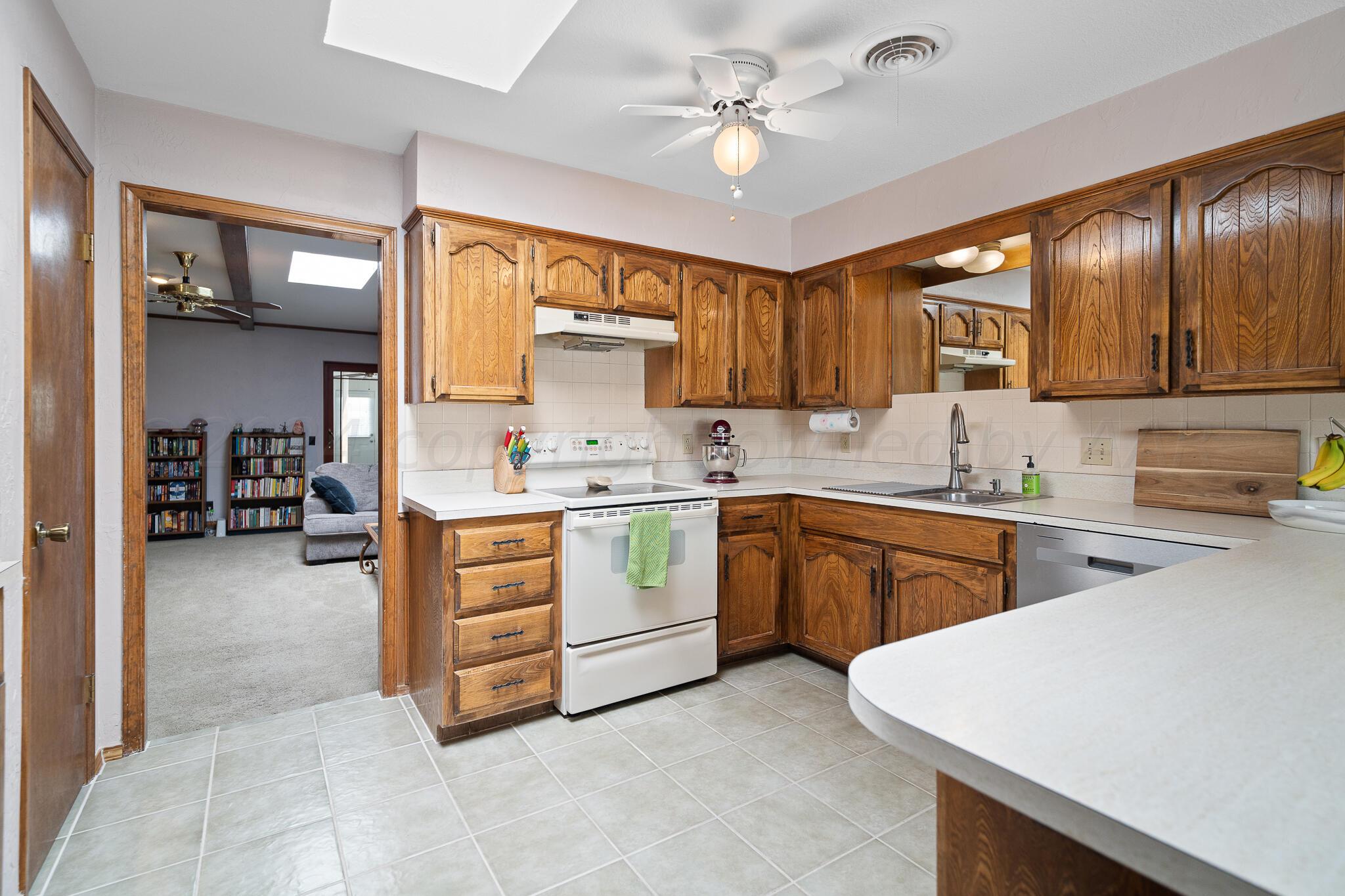 4202 Charles Street Amarillo, TX 79106 - Photo 10 of 25 a kitchen with a stove a sink and a refrigerator