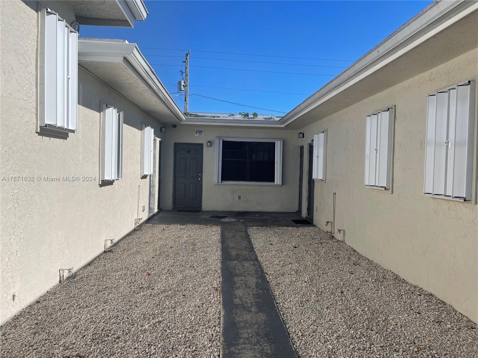 17325 Homestead Avenue, Unit 2 Miami, FL 33157 - Photo 2 of 5 a view of a house with large windows