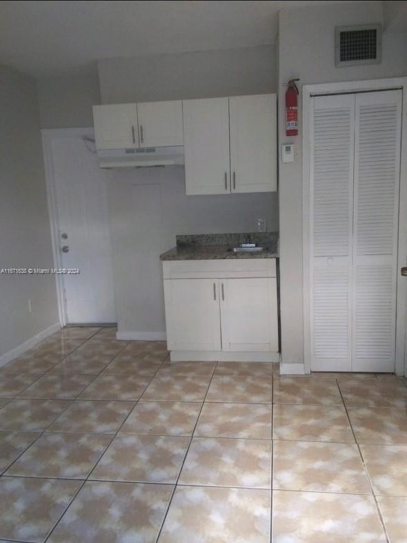 17325 Homestead Avenue, Unit 2 Miami, FL 33157 - Photo 5 of 5 a kitchen with a stove cabinets and a refrigerator