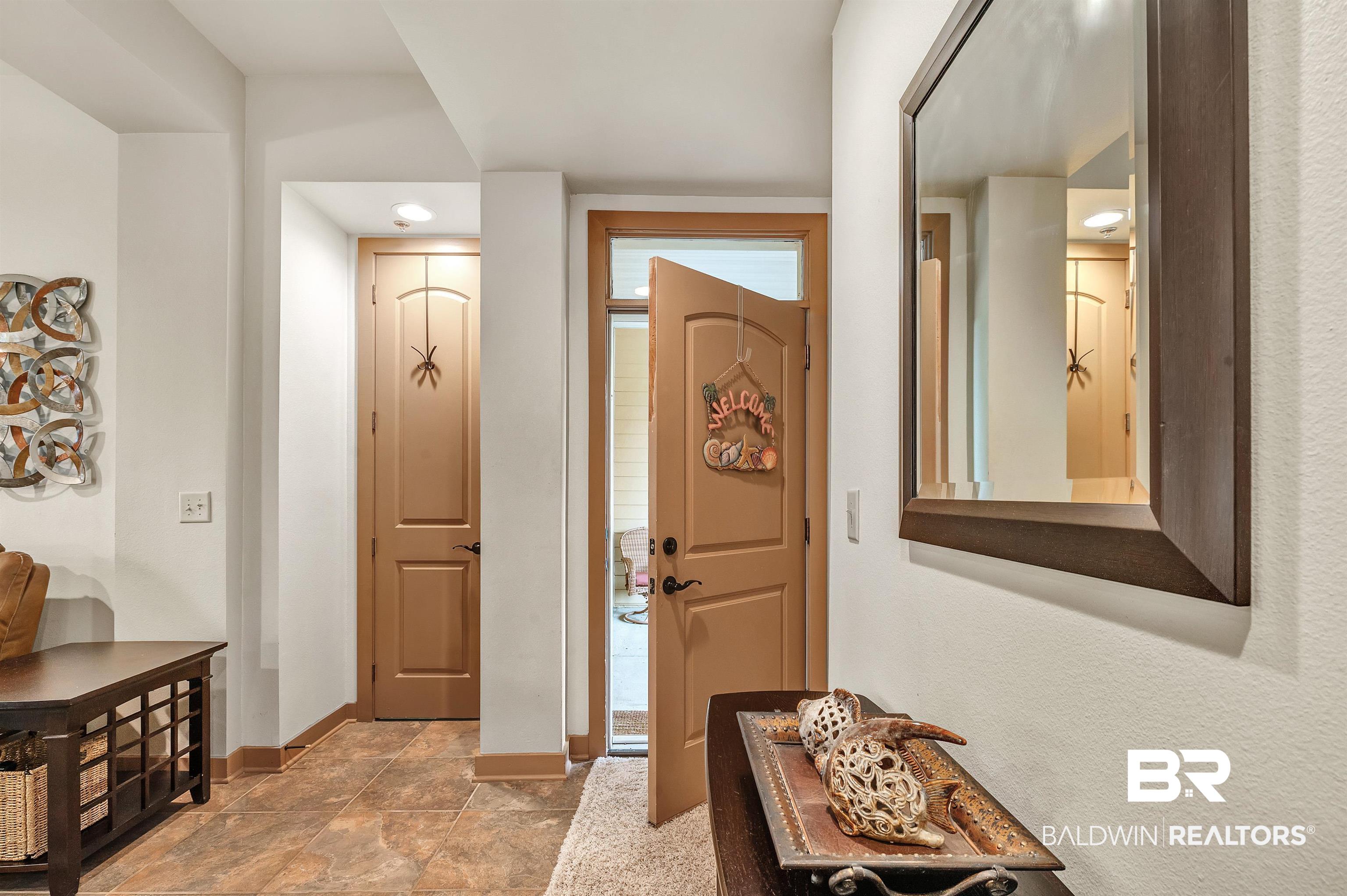 1430 Regency Road, Unit C201 Gulf Shores, AL 36542 - Photo 22 of 54 Foyer entrance featuring baseboards and stone finish floors