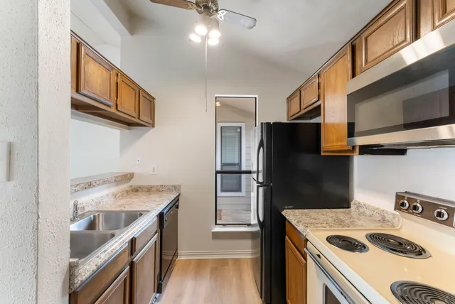 a kitchen that has a sink and a stove top oven