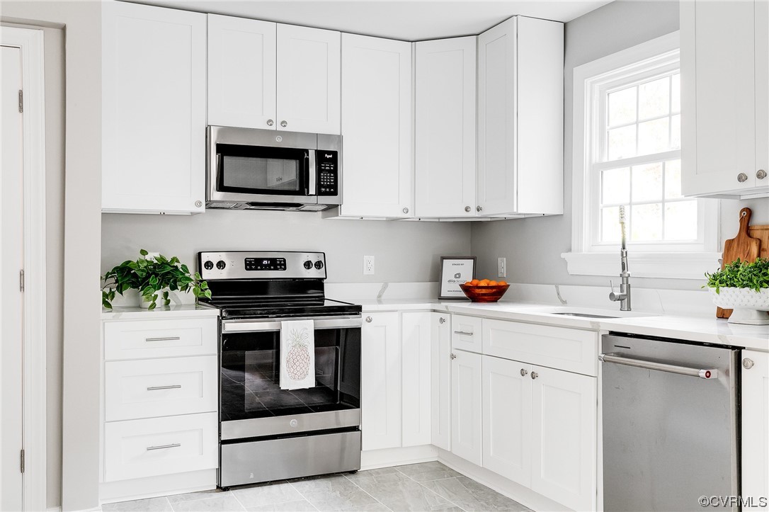 2225 Brookwood Road Richmond, VA 23235 - Photo 11 of 34 a kitchen with white cabinets and white appliances