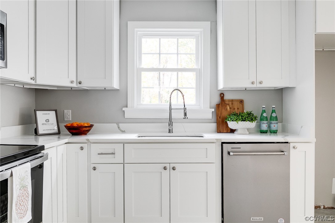 2225 Brookwood Road Richmond, VA 23235 - Photo 12 of 34 a kitchen with stainless steel appliances granite countertop white cabinets sink and a window