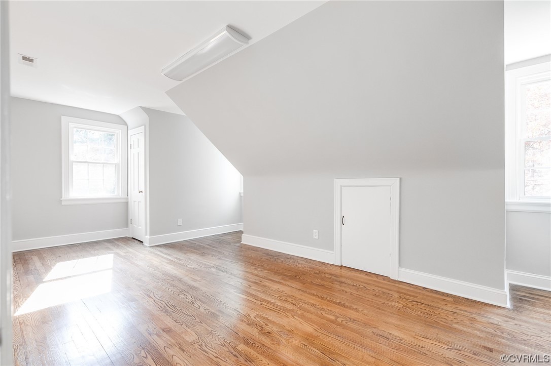 2225 Brookwood Road Richmond, VA 23235 - Photo 28 of 34 an empty room with wooden floor and windows