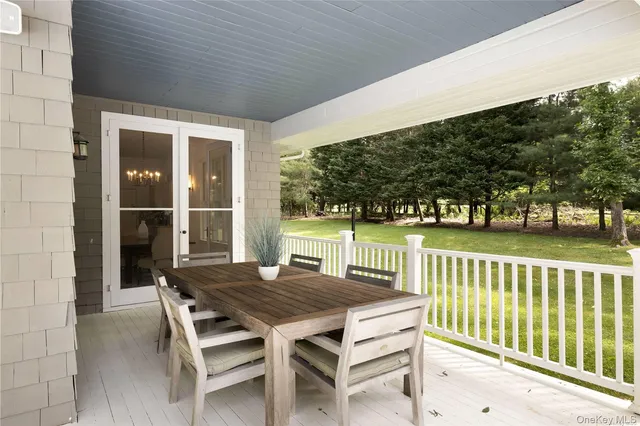 a view of a wooden chairs and table in the balcony