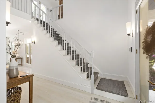 a view of entryway and hall with wooden floor