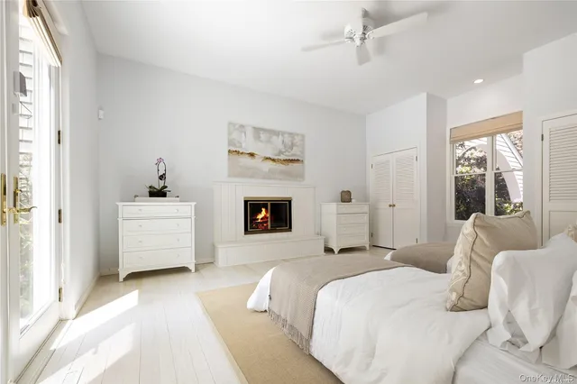 a bedroom with a white bed and a couch