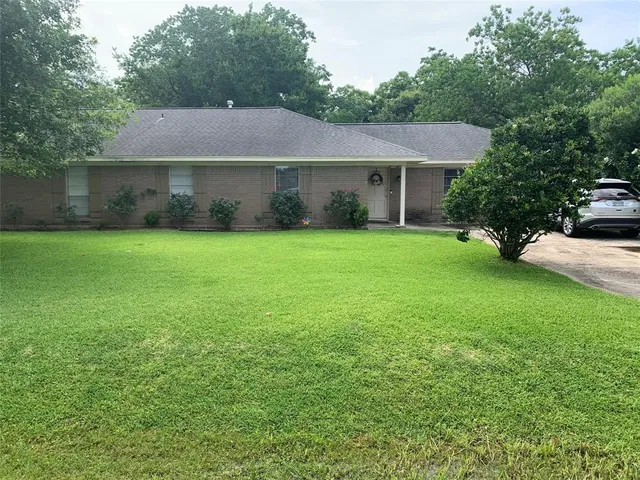 a view of a house with a yard and a garden