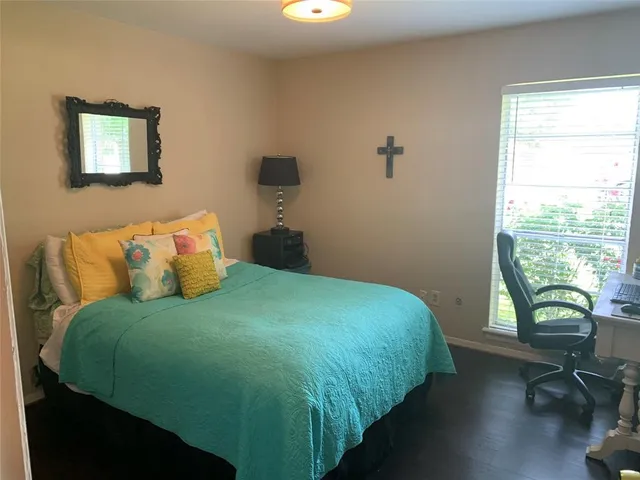 a bedroom with a bed window and table