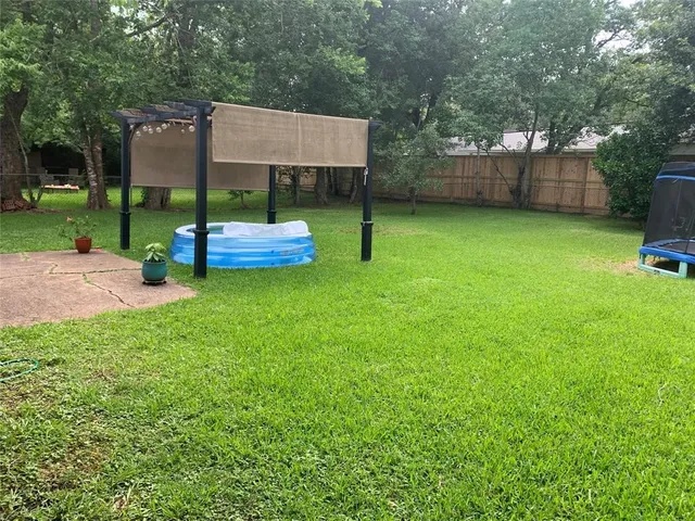 a view of a backyard with a sitting area and slide