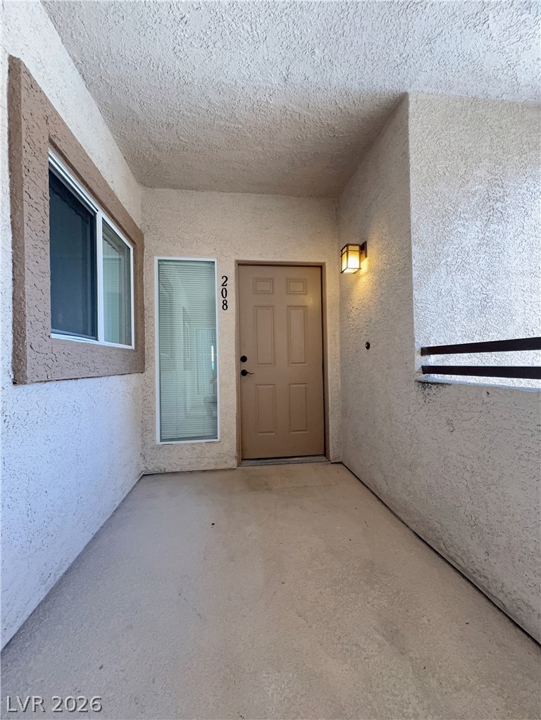 8725 West Flamingo Road, Unit 208 Las Vegas, NV 89147 - Photo 2 of 16 This inviting entrance features a functional door with surrounding architectural details, creating a welcoming approach.