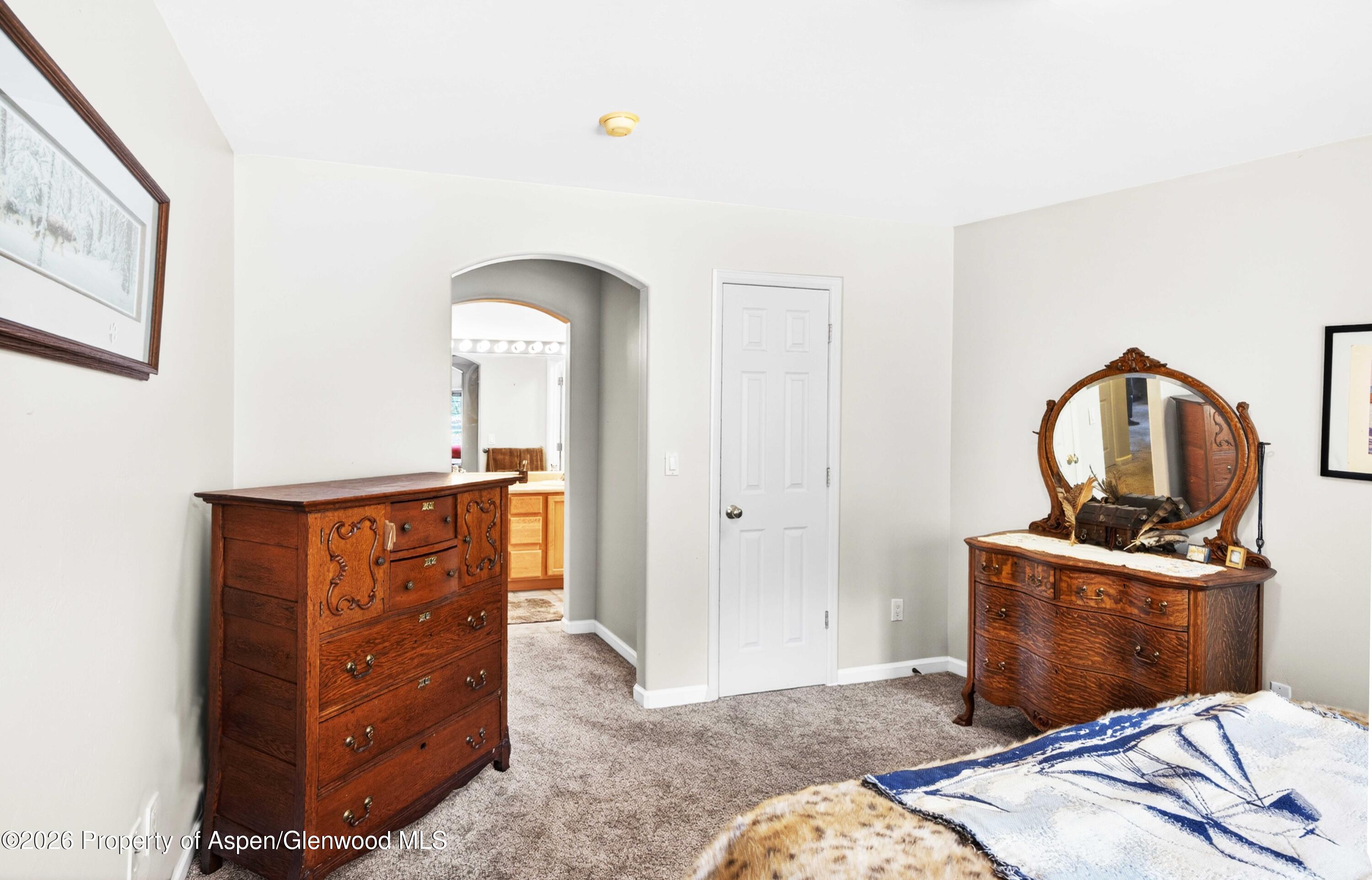 608 Lariat Loop New Castle, CO 81647 - Photo 16 of 32 a bedroom with a bed and wooden floor