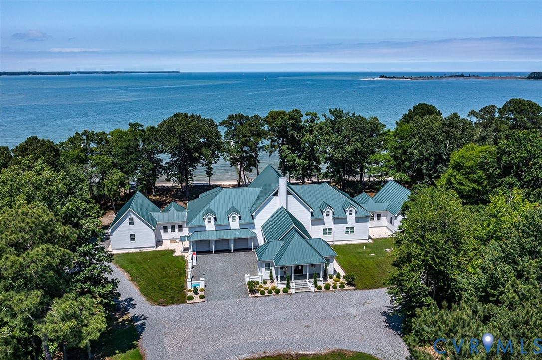 a view of a lake with a big yard and potted plants