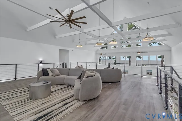 a living room with lots of furniture and wooden floor