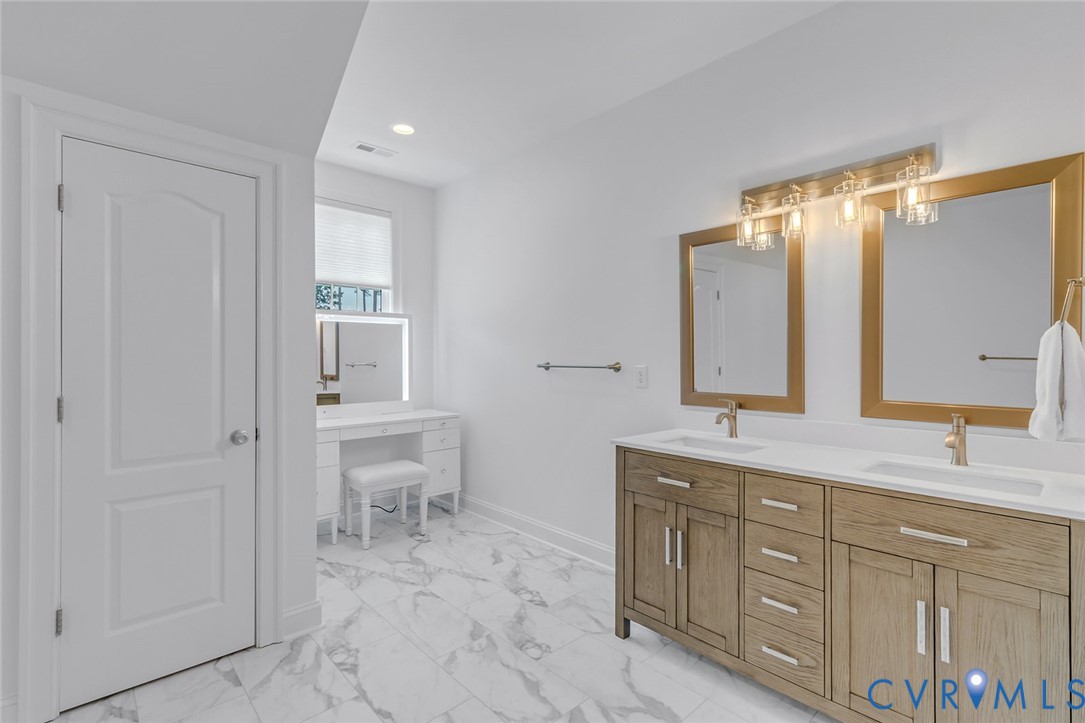 3315 Windmill Point Road White Stone, VA 22578 - Photo 33 of 49 a spacious bathroom with a double vanity sink and a mirror