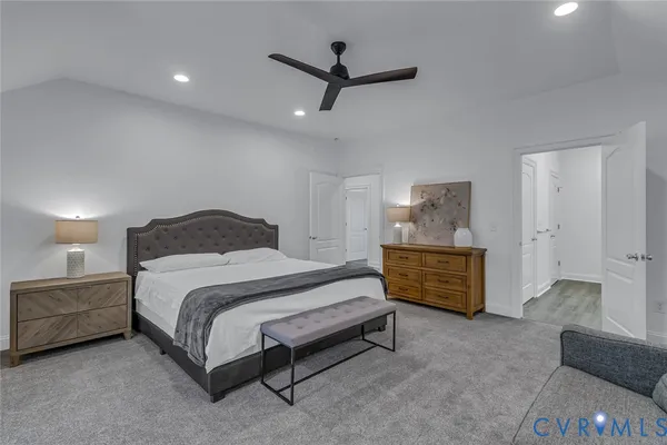 a bedroom with a bed and ceiling fan