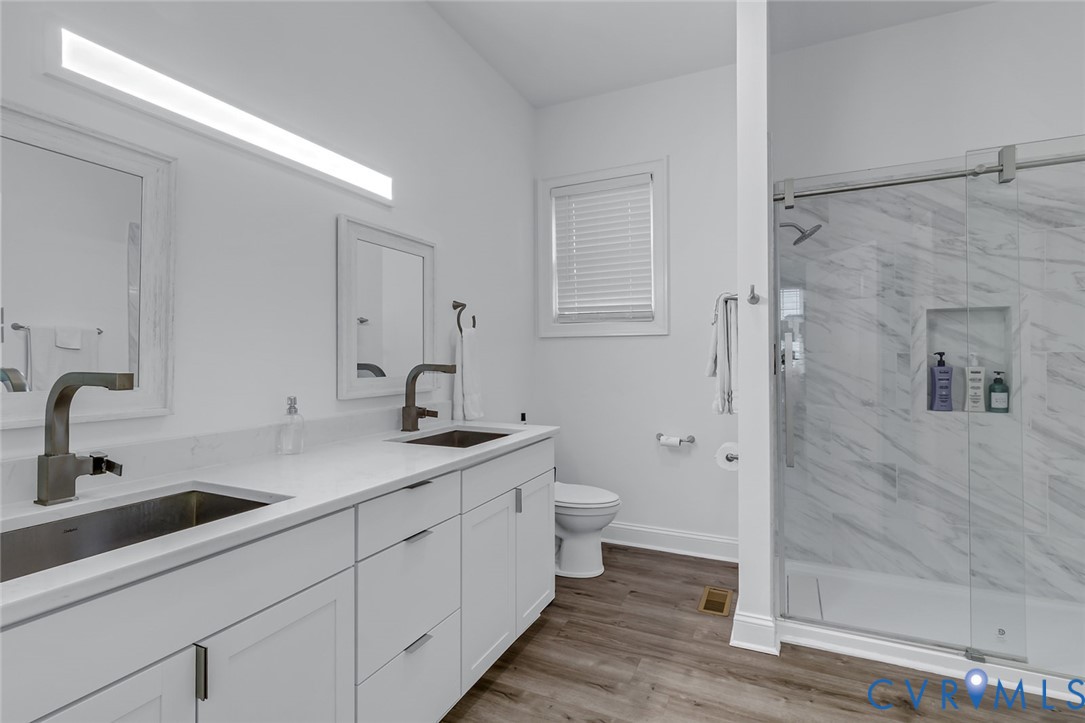 3315 Windmill Point Road White Stone, VA 22578 - Photo 46 of 49 a bathroom with a double vanity sink toilet and shower