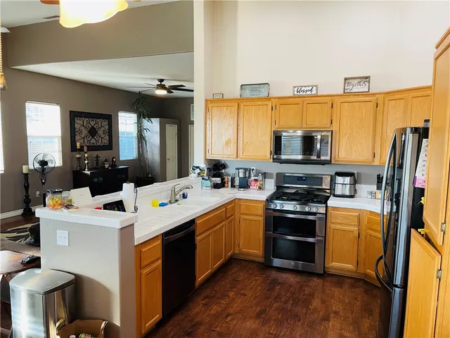 a kitchen with a refrigerator and a stove top oven