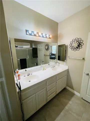 a view of a patio with table and chairs under an umbrella