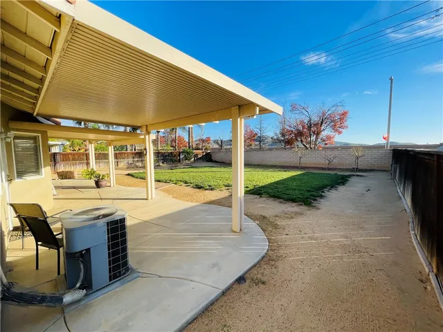 a view of a big house with a big yard and large trees