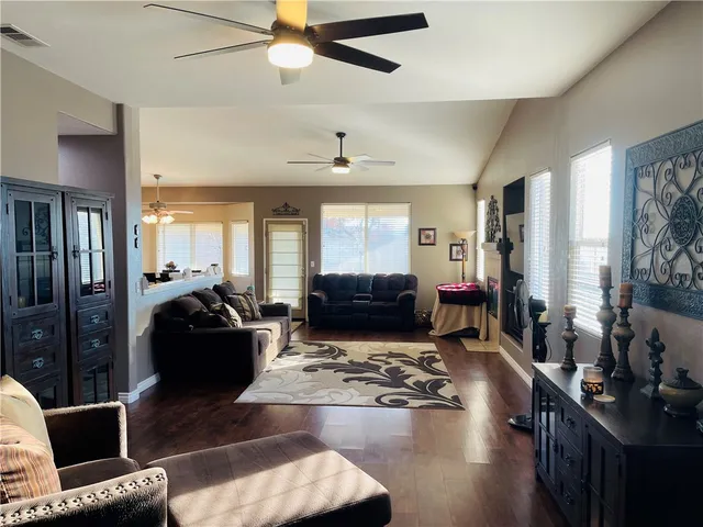 a living room with furniture window and a wooden floor