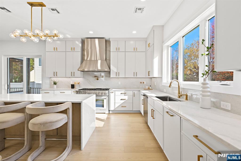 187 Brookfield Avenue Paramus, NJ 07652 - Photo 5 of 22 a kitchen with a sink stove and cabinets