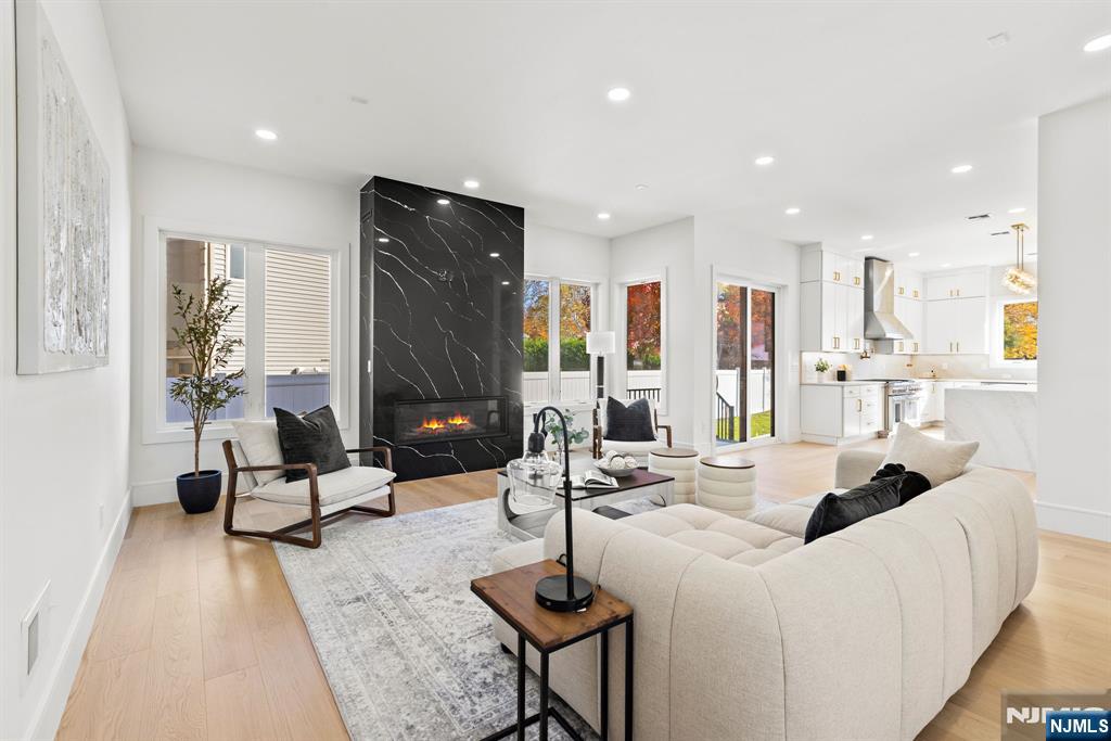 187 Brookfield Avenue Paramus, NJ 07652 - Photo 6 of 22 a living room with furniture a large window and wooden floor