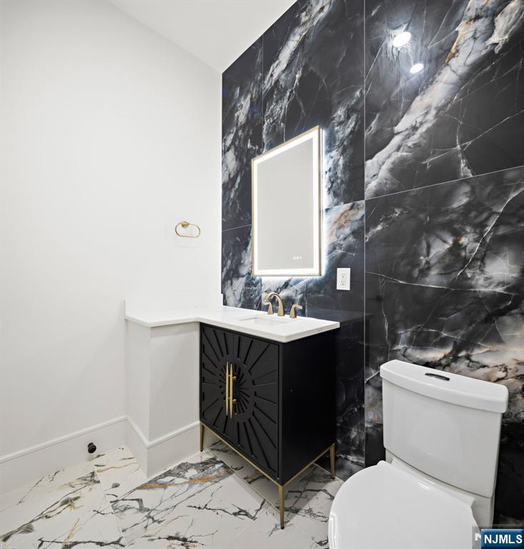 187 Brookfield Avenue Paramus, NJ 07652 - Photo 9 of 22 a bathroom with a sink vanity mirror and toilet