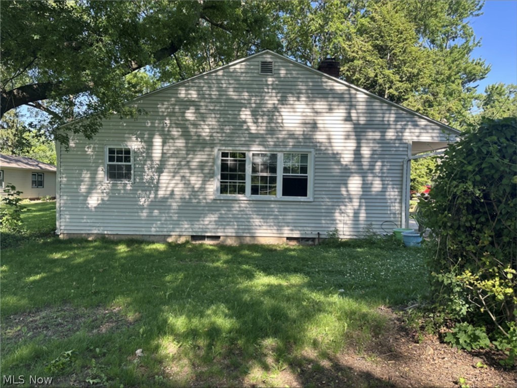10970 Durkee Road Grafton, OH 44044 - Photo 1 of 9 Siding exterior with multiple windows, a gable roof, and an exposed foundation
