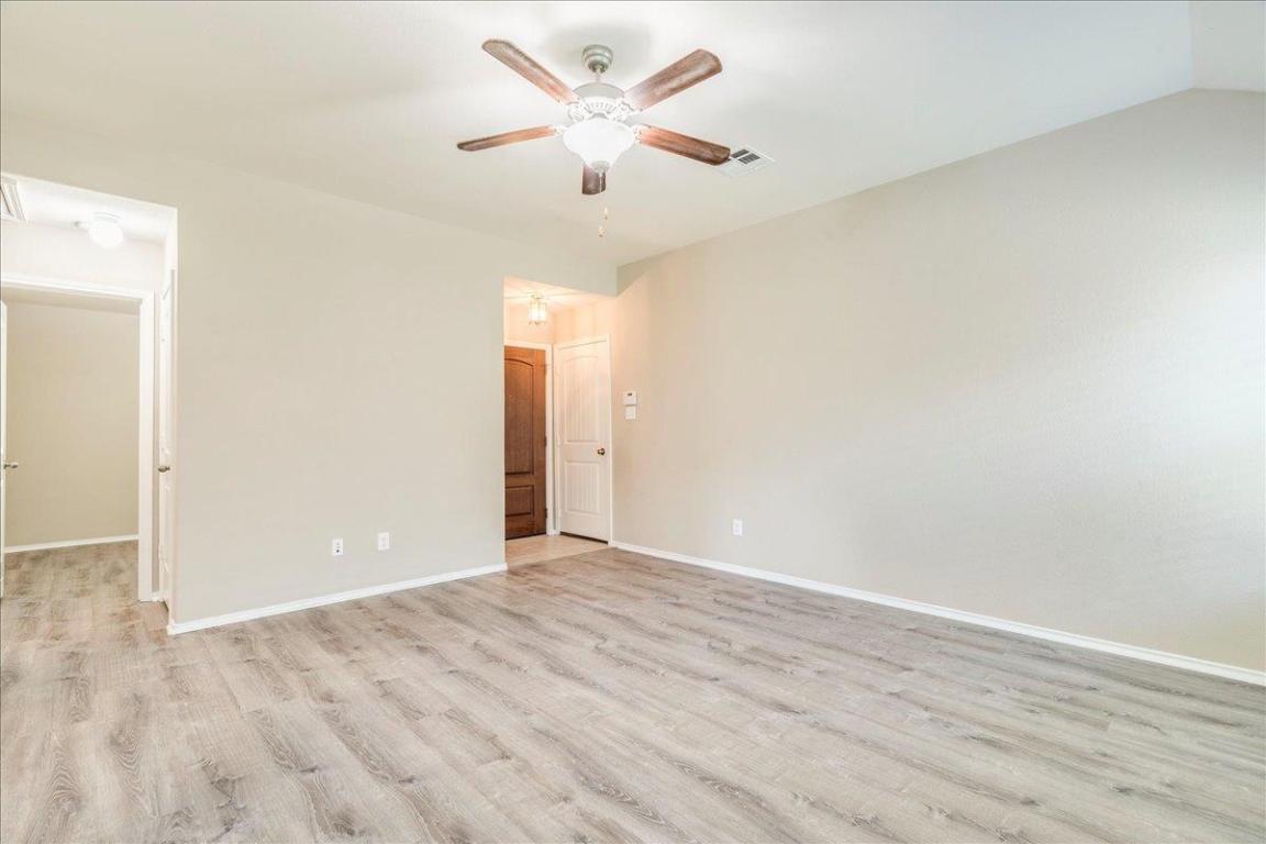 185 Housefinch Loop Leander, TX 78641 - Photo 17 of 39 wooden floor in an empty room