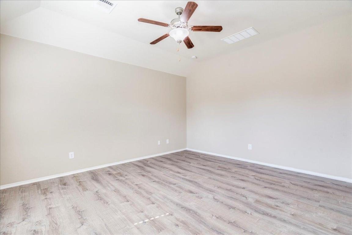 185 Housefinch Loop Leander, TX 78641 - Photo 18 of 39 wooden floor in a empty room