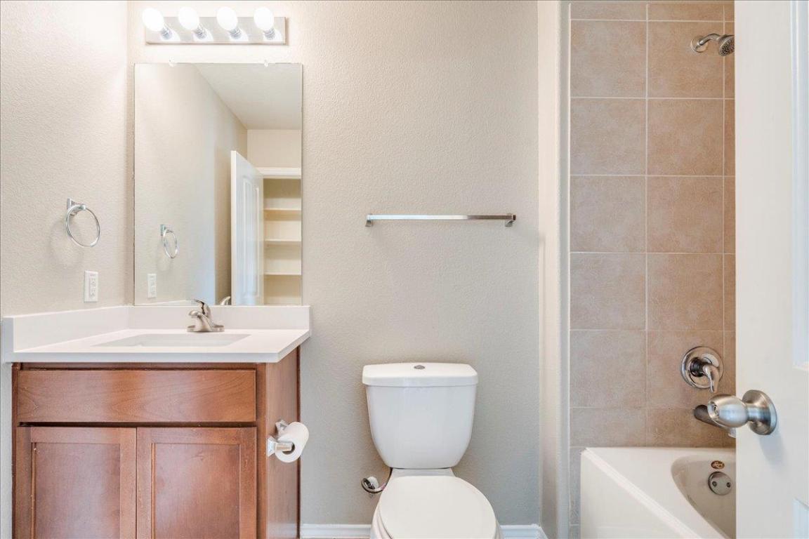 185 Housefinch Loop Leander, TX 78641 - Photo 20 of 39 a bathroom with a toilet sink and mirror