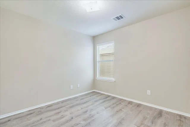 a view of an empty room and wooden floor