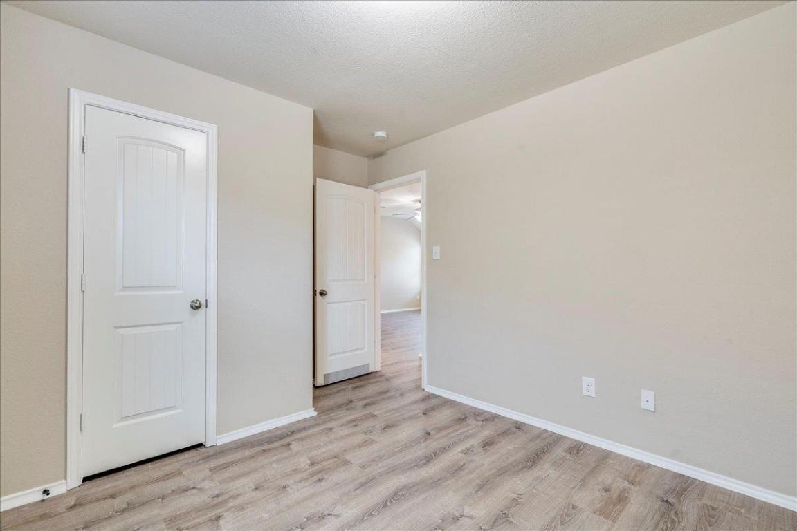 185 Housefinch Loop Leander, TX 78641 - Photo 25 of 39 a view of an empty room and wooden floor