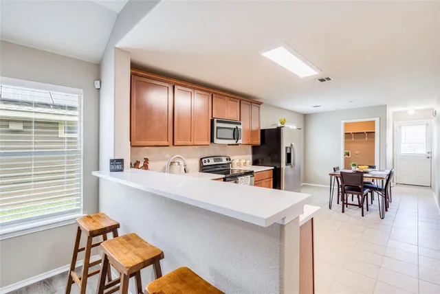 a kitchen with a cabinets and chairs