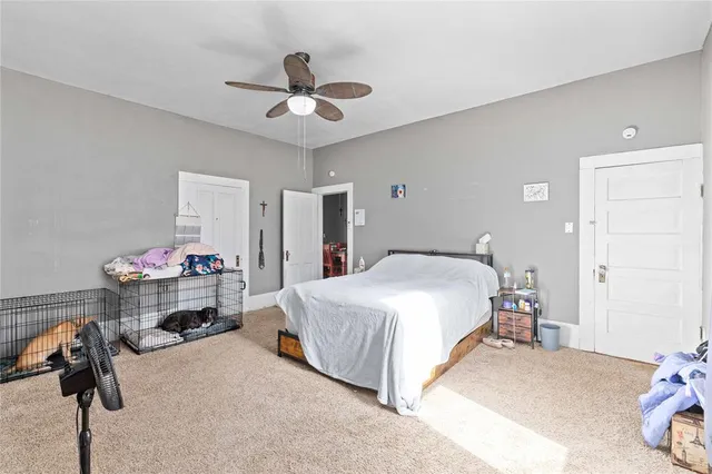 a bedroom with a bed and a chandelier